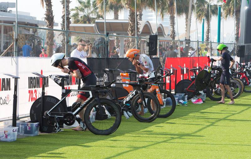 Dubai, United Arab Emirates - Participants changing for the run at the Ironman race at Jumeirah open beach, Dubai. Leslie Pableo for The National