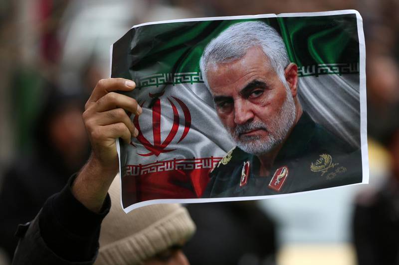 FILE PHOTO: An Iranian holds a picture of late General Qassem Soleimani, head of the elite Quds Force, who was killed in an air strike at Baghdad airport, as people gather to mourn him in Tehran, Iran January 4, 2020. Nazanin Tabatabaee/WANA (West Asia News Agency) via REUTERS ATTENTION EDITORS - THIS IMAGE HAS BEEN SUPPLIED BY A THIRD PARTY/File Photo