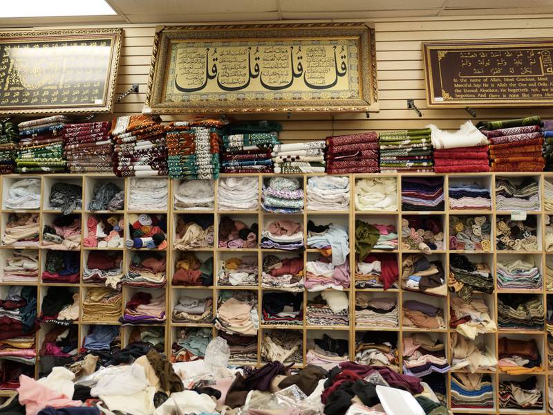 Headscarves and prayer rugs for sale at Al Anwar Islamic Fashions. Photo: Steve LaBate