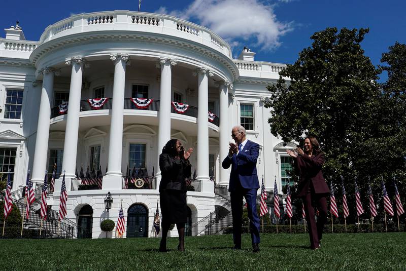 US President Joe Biden is flanked by Ketanji Brown Jackson and Vice President Kamala Harris as they arrive for the celebration. Reuters