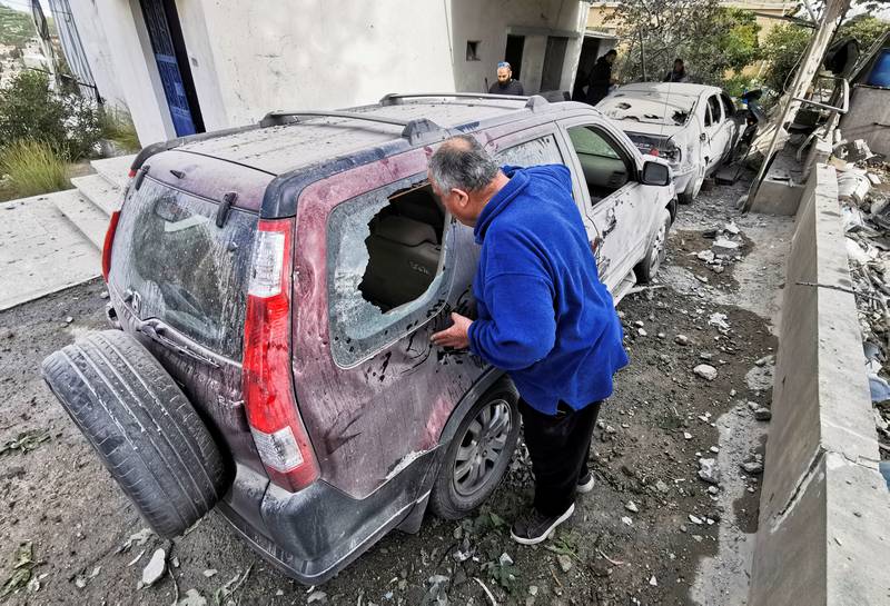 A man looks at a damaged vehicle near the site of an explosion, near Sidon in southern Lebanon, April 12, 2022.  REUTERS/Ali Hankir   NO RESALES.  NO ARCHIVES. 