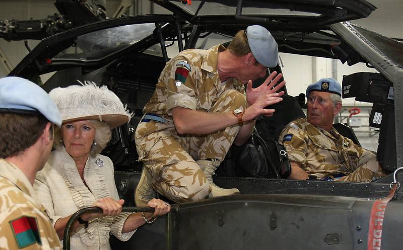 Prince Charles is shown an Apache helicopter by crew members at Wattisham Airfield in 2009