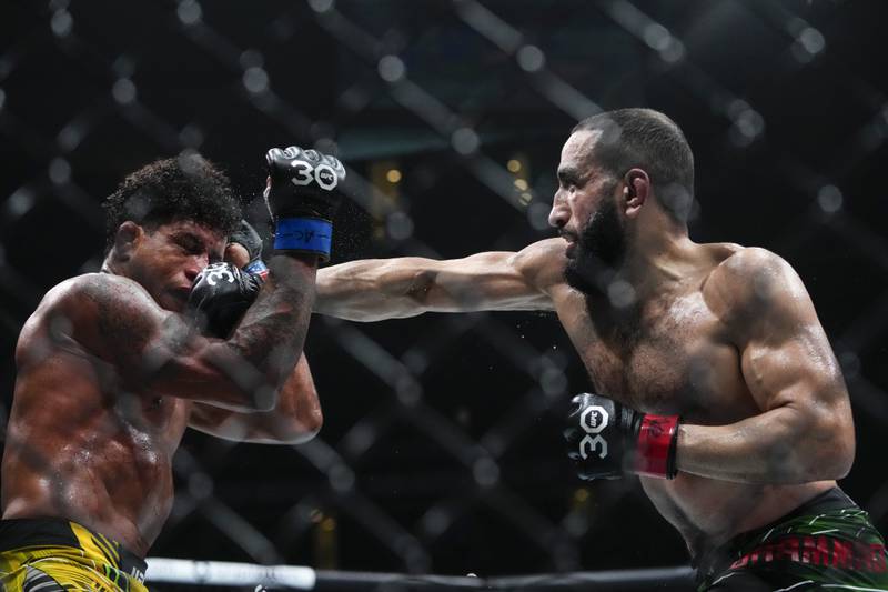 Belal Muhammad lands a punch on Gilbert Burns during the fourth round of their welterweight bout at UFC 288. AP
