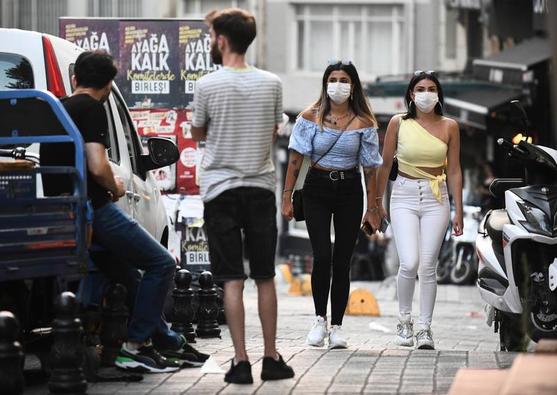 Turkish people wearing face masks walk in Istanbul. AP Photo