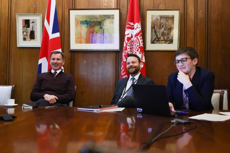 Mr Hunt, left, works on his budget speech with his team. Photo: HM Treasury