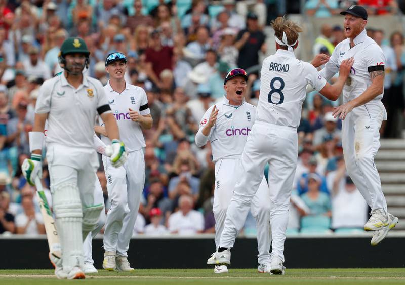 England's Stuart Broad celebrates with teammates after the dismissal of South Africa's Dean Elgar. AFP