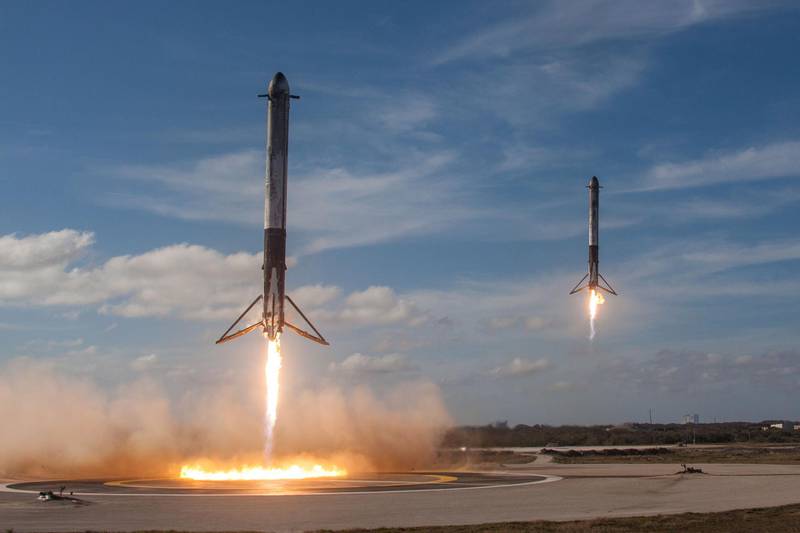 The solid rocket boosters of SpaceX's first Falcon Heavy rocket come back for landing at the Kennedy Space Center in Florida, U.S., February 6, 2018.    SpaceX/Handout via REUTERS    ATTENTION EDITORS - THIS IMAGE WAS PROVIDED BY A THIRD PARTY.  NO RESALES.  NO ARCHIVES.