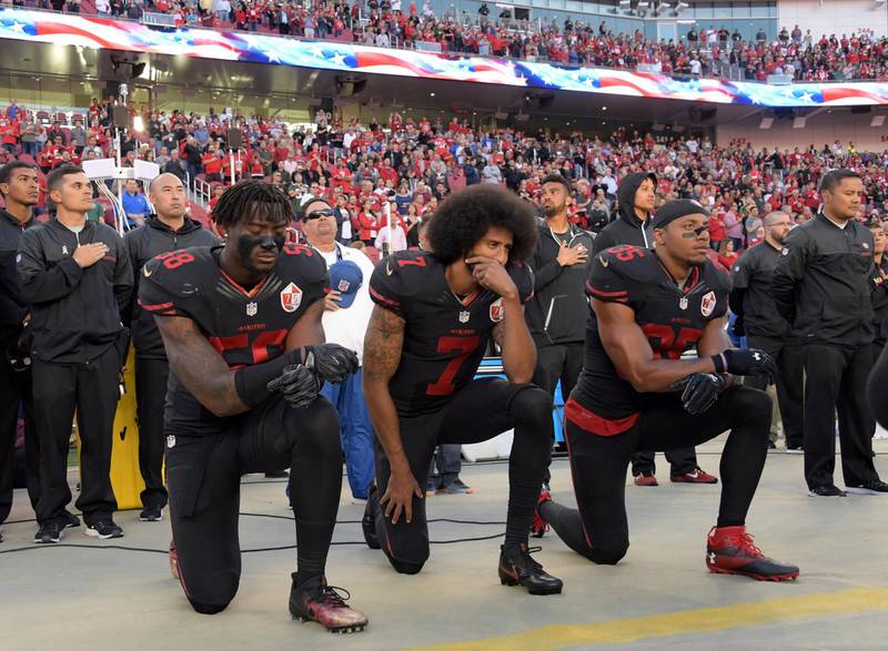San Francisco 49ers outside linebacker Eli Harold (58), quarterback Colin Kaepernick (7) and free safety Eric Reid (35) kneel in protest during the playing of the national anthem before a NFL game against the Arizona Cardinals in Santa Clara, California, Oct 6, 2016.   Mandatory Credit: Kirby Lee-USA TODAY Sports/File Photo
