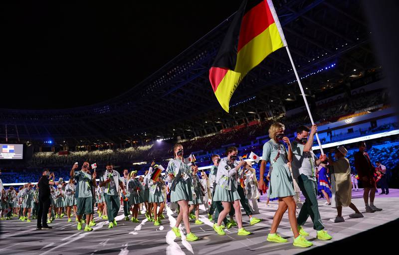 Patrick Hausding and Laura Ludwig, of Germany, lead their contingent during the athletes parade at the opening ceremony.