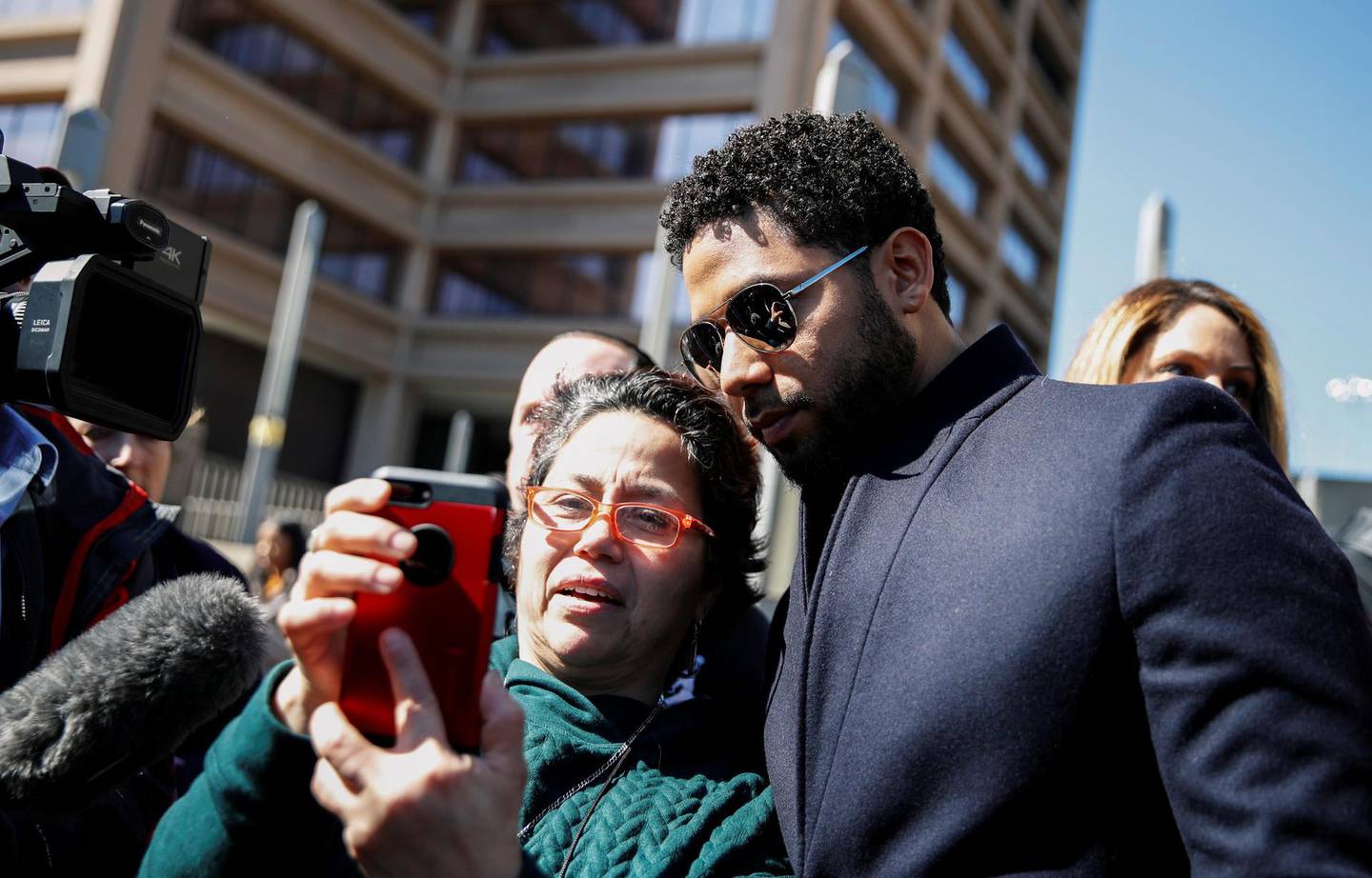 Actor Jussie Smollett poses for a picture with a fan as he leaves court after charges against him were dropped by state prosecutors in Chicago, Illinois, U.S. March 26, 2019. REUTERS/Kamil Krzaczynski