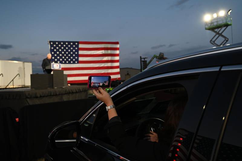 A supporter records Democratic Presidential candidate and former US Vice President Joe Biden as he speaks at a car rally at the Michigan State Fairgrounds in Detroit, Michigan. AFP