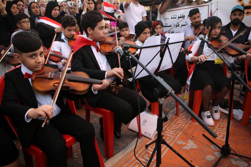 Music school students take part in the protests near the Basra provincial council building. AP