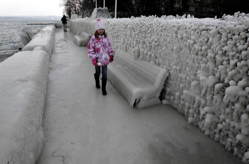 A girl walks on the ice covered pavement along the bank of Leman Lake in Versoix near Geneva February 5, 2012. Bitterly cold weather sweeping across Europe claimed more victims on Sunday and brought widespread disruption to transport services, with warnings that the chilling temperatures would remain into next week. REUTERS/Denis Balibouse (SWITZERLAND - Tags: ENVIRONMENT) *** Local Caption ***  DBA08_EUROPE-WEATHE_0205_11.JPG