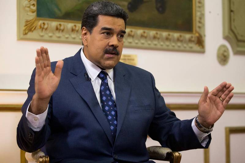 Venezuela's President Nicolas Maduro speaks during an interview with The Associated Press at Miraflores presidential palace in Caracas, Venezuela, Thursday, Feb. 14, 2019. Maduro is inviting a U.S. special envoy to come to Venezuela after revealing during the interview that his foreign minister recently held secret meetings with the U.S. official in New York. (AP Photo/Ariana Cubillos)
