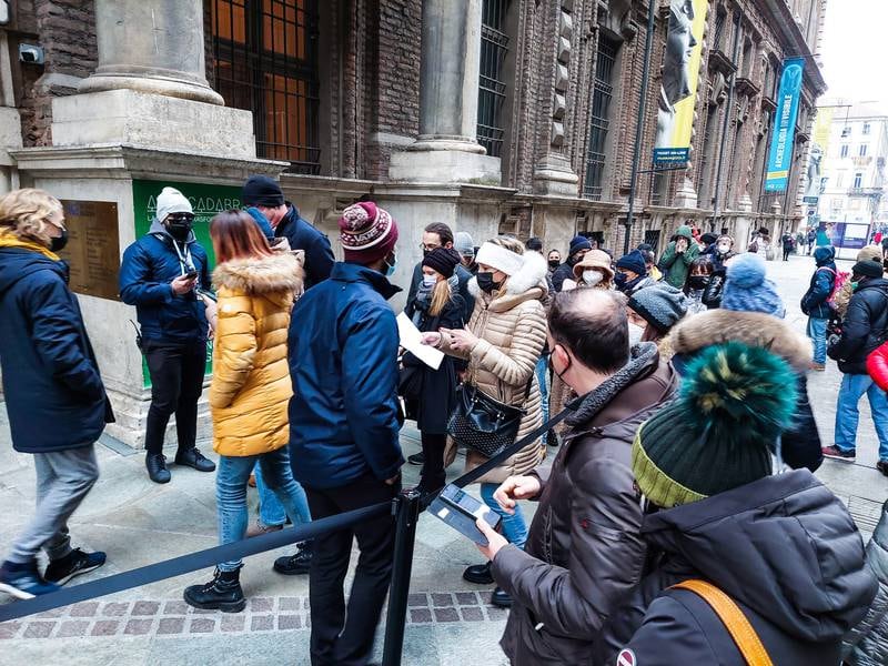 People queue for Covid-19 status checks before entering the Egyptian Museum, in Turin, northern Italy. EPA
