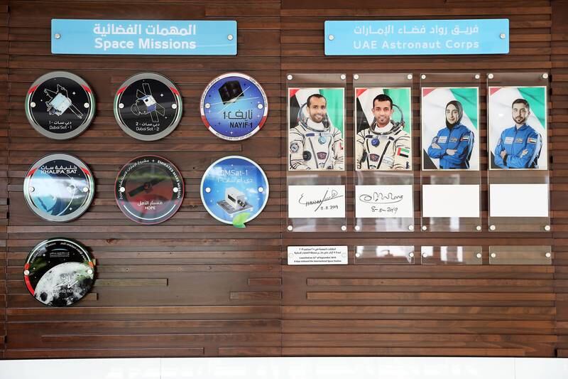 Photos of UAE astronauts and badges of space missions hang on the wall inside the Mohammed bin Rashid Space Centre.