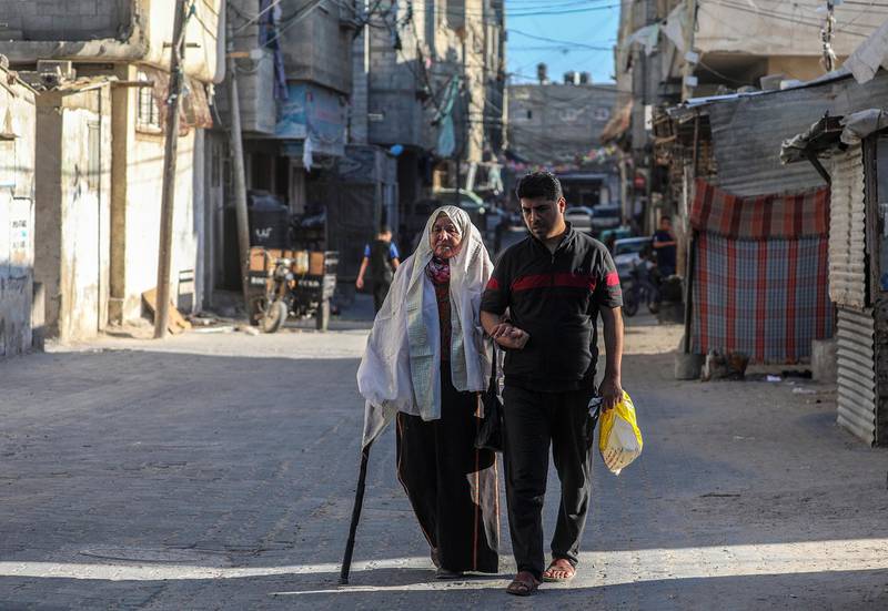 Palestinian refugee Amna Abu Mustafa, 88, born in 1932 in Beersheba, walks with her grandson near her house in the streets of Khan Younis refugee camp in the Gaza Strip.  World Refugee Day is marked on 20 June each year to highlight the suffering of the tens of millions of people forced to flee their homes due to war or persecution. Nearly one-third of the registered Palestine refugees, more than 1.5 million individuals, live in 58 recognized Palestine refugee camps in Jordan, Lebanon, the Syrian Arab Republic, the Gaza Strip and the West Bank, including East Jerusalem.  EPA
