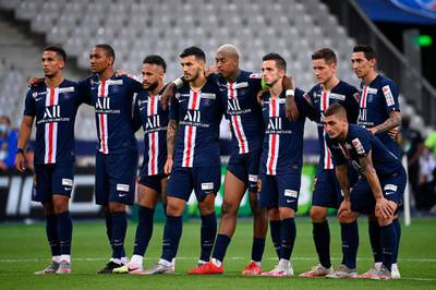 Paris Saint-Germain's players watch the penalty shoot-out. AFP
