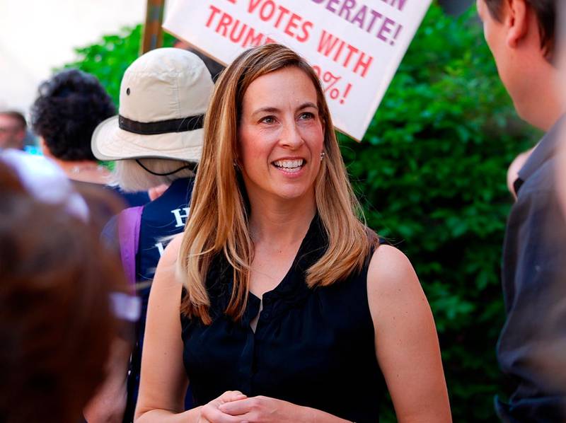 FILE- In this May 19, 2017, file photo, Mikie Sherrill joins protesters with NJ 11th for Change outside of U.S. Rep. Rodney Frelinghuysen's Morristown office. Sherrill, a former Navy helicopter pilot and federal prosecutor, is looking to capture a GOP congressional seat in New Jersey. Sherrill is one of some 200 women who have won their primaries for U.S. House, with 94 of these candidates surviving crowded fields with three or more candidates, according to an analysis of election results. (Justin Zaremba/NJ Advance Media via AP, File)