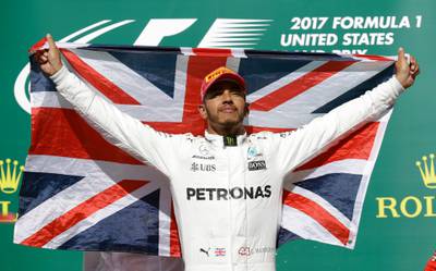 Mercedes driver Lewis Hamilton, of Britain, celebrates after winning the Formula One U.S. Grand Prix auto race at the Circuit of the Americas, Sunday, Oct. 22, 2017, in Austin, Texas. (AP Photo/Darron Cummings)