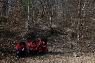 Paramedics find low ground after an air-raid siren sounds on the outskirts of Novoiavorivsk. Getty Images