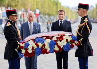 Britain's King Charles III and French President Emmanuel Macron lay a wreath of remembrance at the Tomb of the Unknown Soldier at the Arc de Triomphe in Paris. AFP