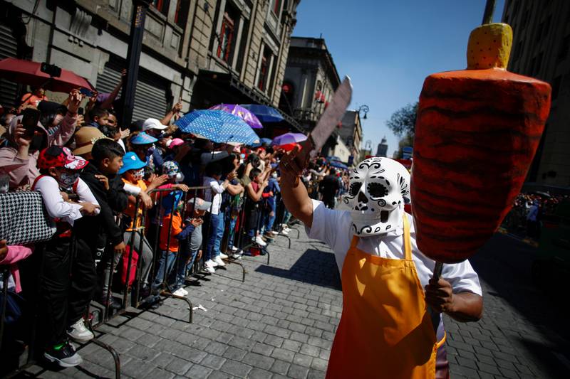 A participant performs as a taquero during the annual Day of the Dead parade in Mexico City. Reuters