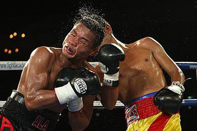 Rey ?Boom Boom? Bautista takes a solid punch from Saichon Sotornpitak in Dubai.