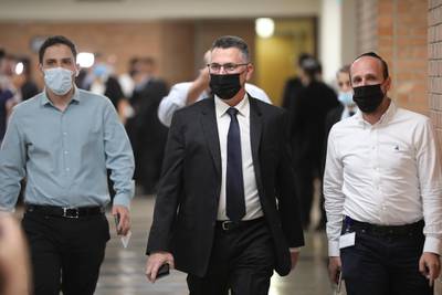 Leader of the Tikva Hadasha party, Gideon Saar, centre, arrives for the special voting session. EPA