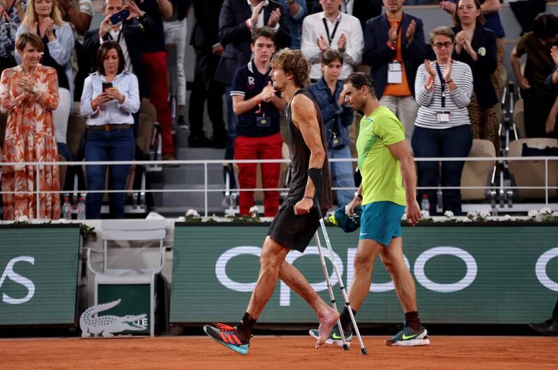Alexander Zverev of Germany walks off the court on crutches at Roland Garros. Getty