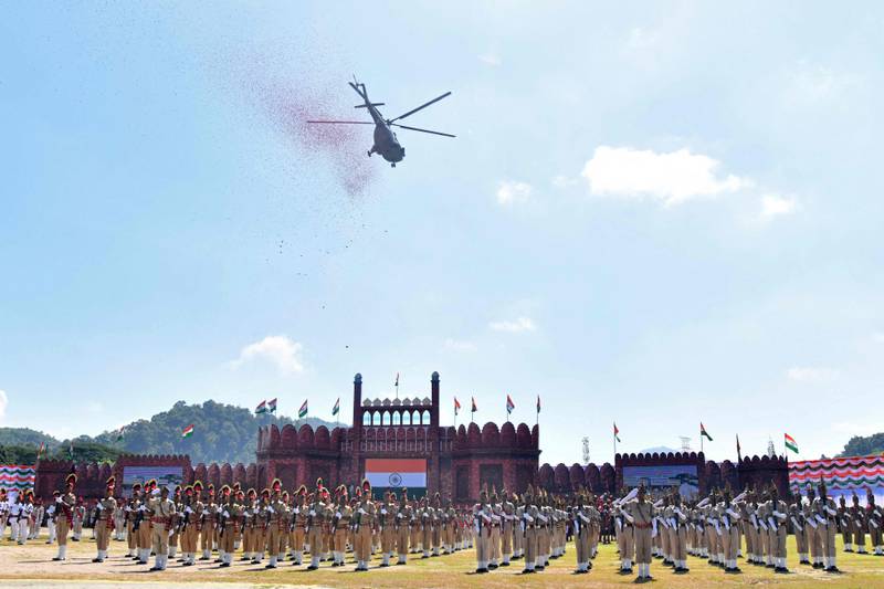 An Indian Air Force helicopter releases thousands of petals during celebrations to mark Independence Day in the north-eastern city of Guwahati. AFP