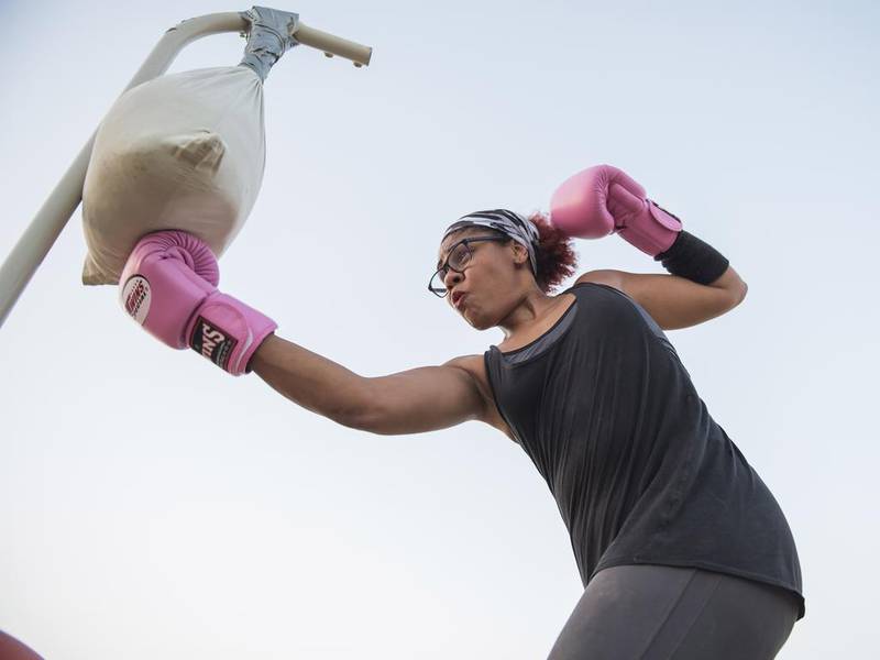 Dee Smith working out with a punching bag she created herself, by stuffing a pillowcase with sand. Vidhyaa for The National  