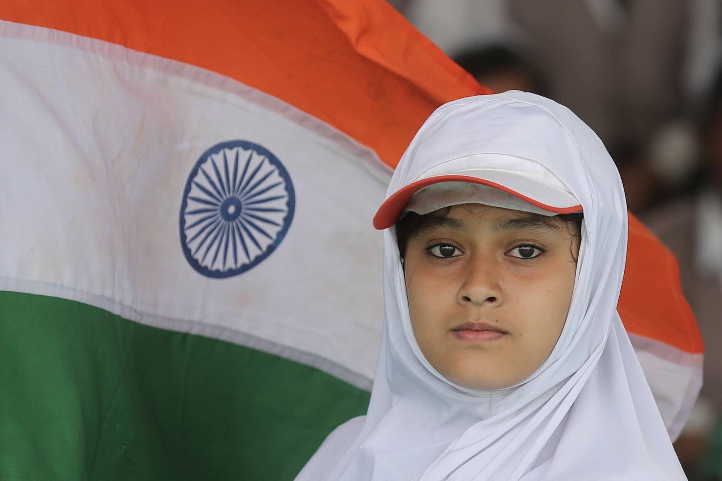 A school pupil stands in front of the Indian flag during a full dress rehearsal for celebrations, ahead of the 75th Independence Day in Bengaluru. EPA