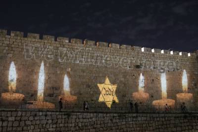 An image of a Star of David that reads 'Jude', German for Jew, resembling those Jews were forced to wear in Nazi Germany, projected on the walls of Jerusalem's Old City. AP