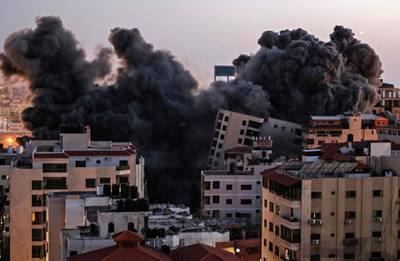 Smoke billows from buildings hit during the Israeli air strikes on Gaza. AFP