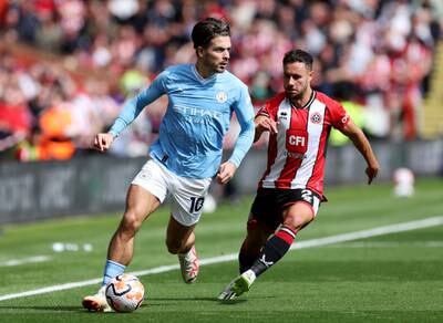 Jack Grealish of Manchester City is pursued by George Baldock of Sheffield United. Getty 