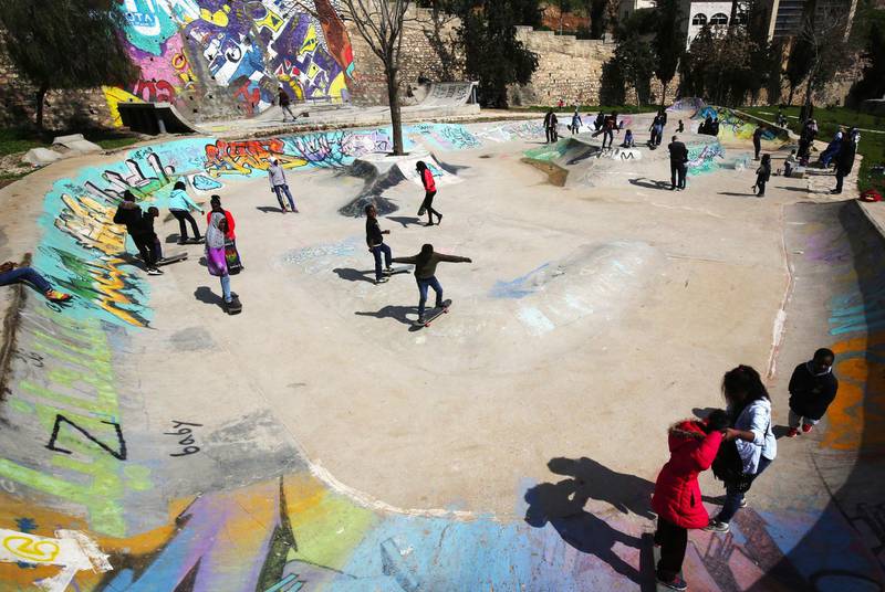 Refugee children skate on February 24, 2018 at the "7Hills Skate Park" in Amman, that was constructed in 2014 by passionate skateboarding volunteers from all over the world thanks to an initiative launched by a German NGO and a local Jordanian association which offers free skateboarding lessons to refugees several times a week.   
Some 140 refugee boys and girls from Sudan, Somalia, Yemen, Iraq, Syria and Palestine come every week to participate in the free lessons at the skate park.  / AFP PHOTO / Khalil MAZRAAWI