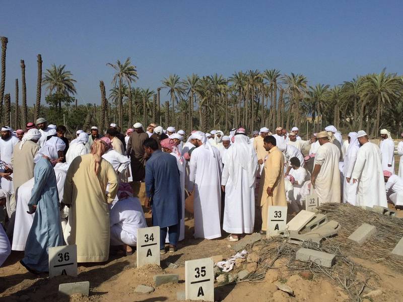 People attend the funeral for the children who died in a house fire in Fujairah. Pawan Singh / The National