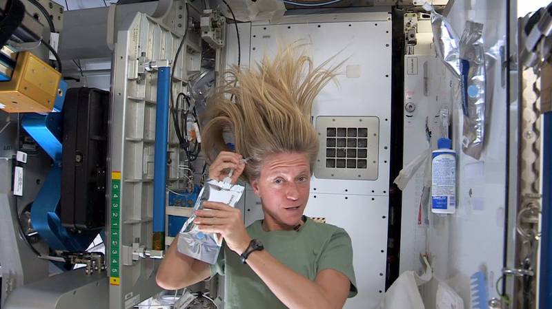 Expedition 36 flight engineer Karen Nyberg washes her hair in space in 2013