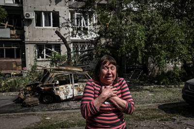 The pain of war hits this woman hard shortly after her apartment building in Slovyansk was damaged by Russian shelling. AFP