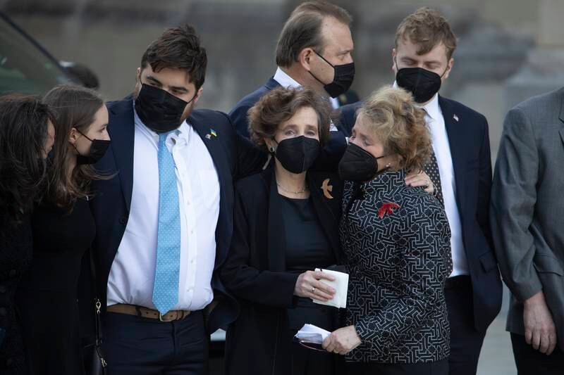 Relatives of Albright comfort one another. EPA
