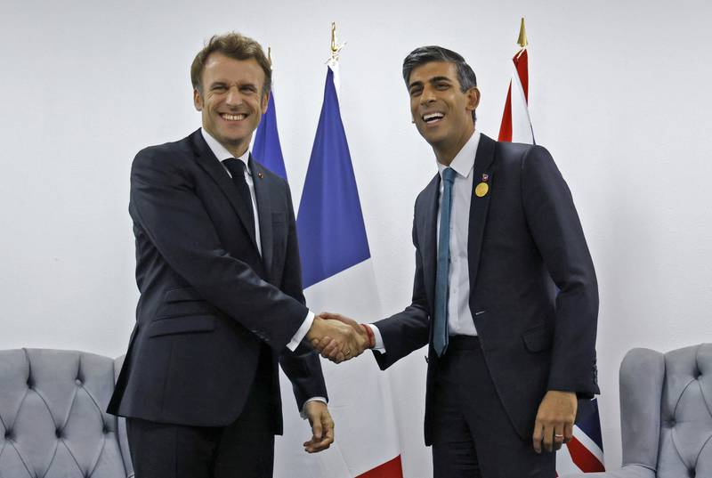 Britain's Prime Minister Rishi Sunak, right, shakes hands with French President Emmanuel Macron during a bilateral meeting at the Cop27 summit in Sharm El Sheikh, Egypt. AP