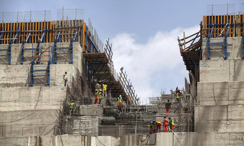 Ethiopian workers construct on March 31, 2015 the Grand Renaissance Dam near the Sudanese-Ethiopian border. Ethiopia began diverting the Blue Nile in May 2013 to build the 6,000 megawatt dam, which will be Africa's largest when completed in 2017. The leaders of Egypt and Ethiopia promised on March 24 to boost cooperation on the Nile river and turn a page on a long-running row over Addis Ababa's controversial dam project. Egypt, heavily reliant for millennia on the Nile for agriculture and drinking water, feared that the Grand Renaissance Dam would decrease its water supply.     AFP PHOTO / ZACHARIAS ABUBEKER (Photo by ZACHARIAS ABUBEKER / AFP)