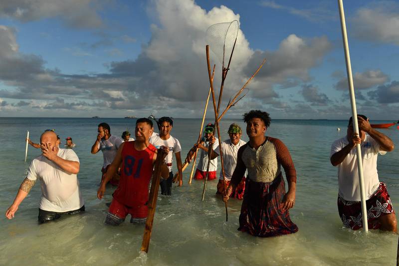 epa07774296 Locals during a traditional fishing practice to round up fish to be cooked on an umu (traditional earth oven) by the lagoon in Funafuti, Tuvalu, 15 August 2019. One of the first casualties of climate change and rising ocean temperatures is the decimation it causes to the fishery stocks. Many of the islanders rely on the fish stock for the basic subsistence and to feed their families. The 50th Pacific Islands Forum and Related Meetings, fostering cooperation between governments comprising 18 countries in the region, run from 13 to 16 August 2019 in Tuvalu.  EPA/MICK TSIKAS  AUSTRALIA AND NEW ZEALAND OUT