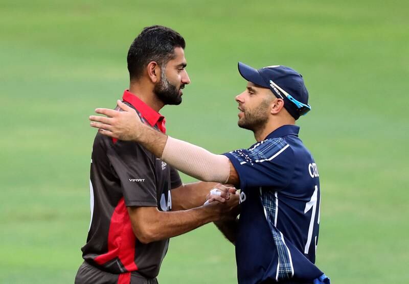 Dubai, United Arab Emirates - October 30, 2019: UAE's Ahmed Raza and Scotland's Kyle Coetzer after the game between the UAE and Scotland in the World Cup Qualifier in the Dubai International Cricket Stadium. Wednesday the 30th of October 2019. Sports City, Dubai. Chris Whiteoak / The National