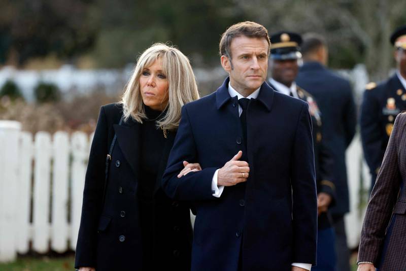 Mr Macron is joined by his wife at Arlington National Cemetery. AFP