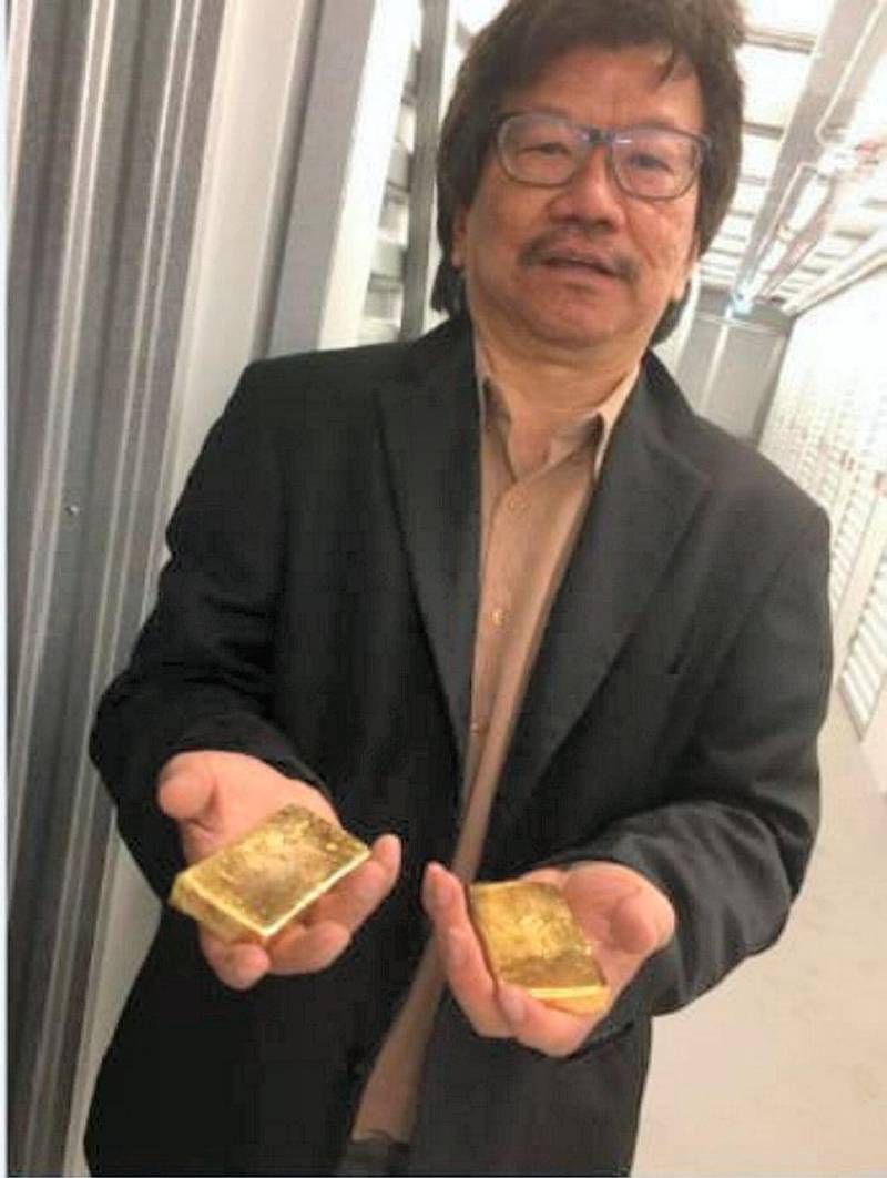 SLIPPERY CUSTOMER: Khoo, pictured holding two pieces of gold, was arrested after Border Force officers seized a consignment at Heathrow Airport, found a prime market for the highly valuable glass eel in East Asia. The delicacy can sell for more than $6,000 per kilo on the black market, Hong Kong media reported. Courtesy: National Crime Agency