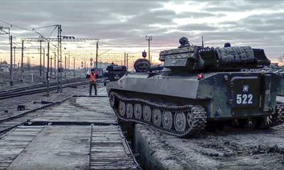 Russian armoured vehicles are loaded on to railway platforms after the end of military drills in southern Russia. AP
