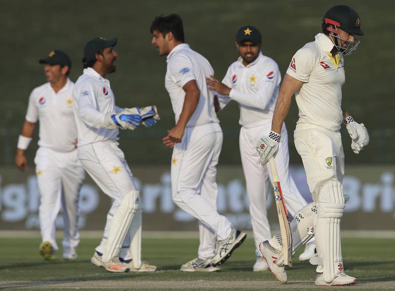 Pakistan's Mir Hamza, center, celebrates after he bowled Australia's Shaun Marsh during their test match against Australia in Abu Dhabi, United Arab Emirates, Thursday, Oct. 18, 2018. (AP Photo/Kamran Jebreili)