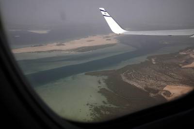 A view of the scenery through the window of Israeli flag carrier El Al's flight LY971, as it is approaching for landing at the airport of Abu Dhabi. EPA